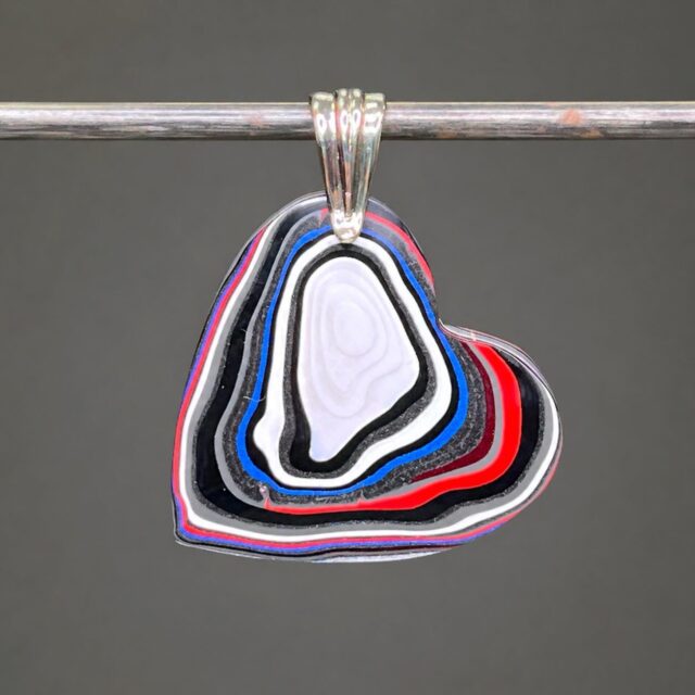 🚘😍🚘 
OH YEAH!!!
This is a genuine MOPAR FORDITE HEART pendant custom cut to showcase the gorgeous paint layers. This is very lightweight and can be worn on both sides. Definitely a collector’s pendant and part of our American automotive history. 
DM me for details.🥰
#fordite #forditejewelry #forditeheart #zacharybloomjewelry #lapidaryjewelry